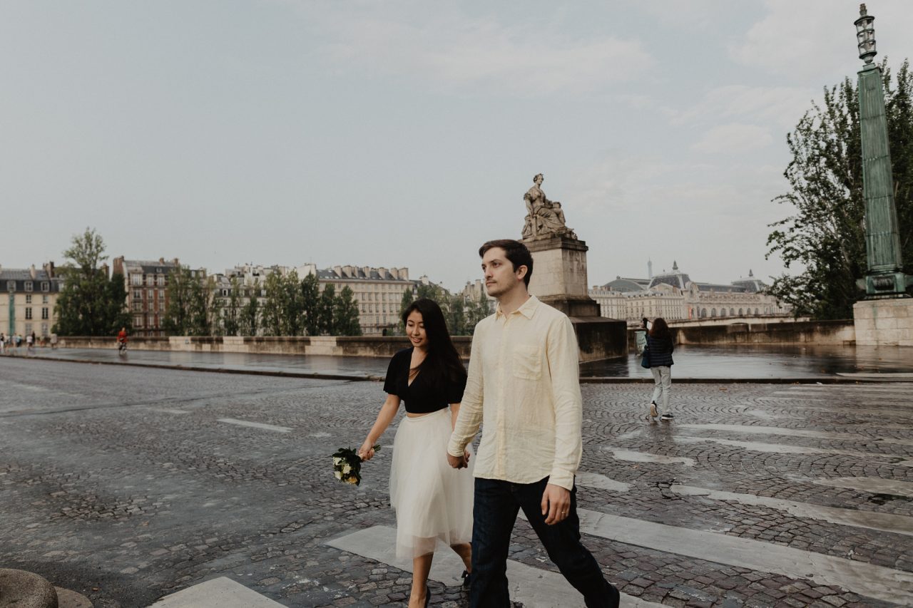 Couple photography crossing street Seine river Paris