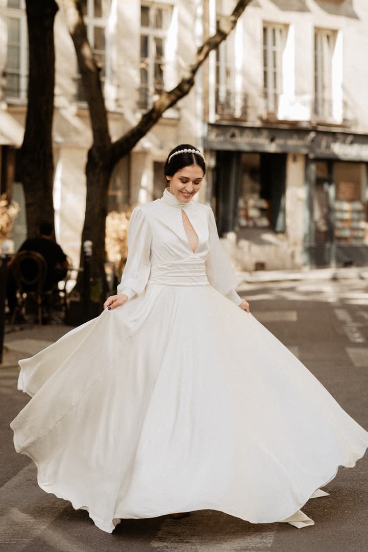 Bride in wedding dress dancing Paris wedding