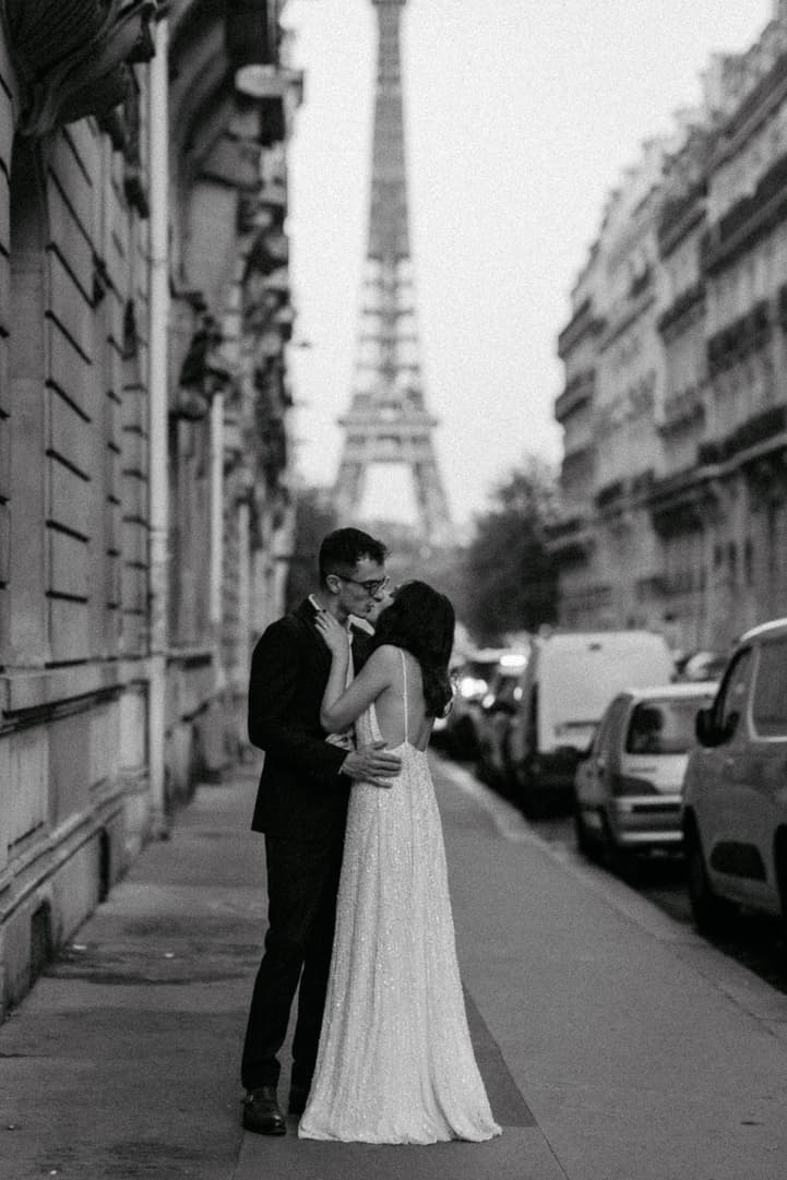 Couple kissing by Eiffel tower