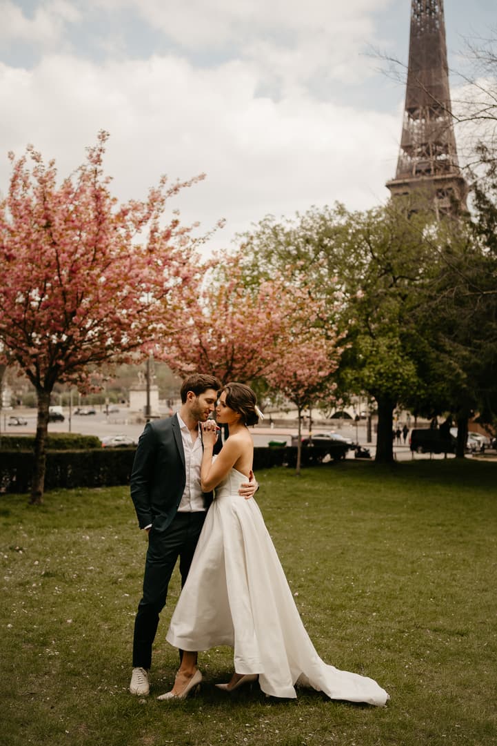 Cherry blossoms spring couple elopement wedding ceremony by Eiffel tower photoshoot