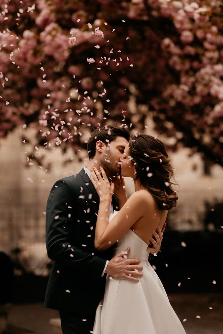 kissing couple under cherry blossoms
