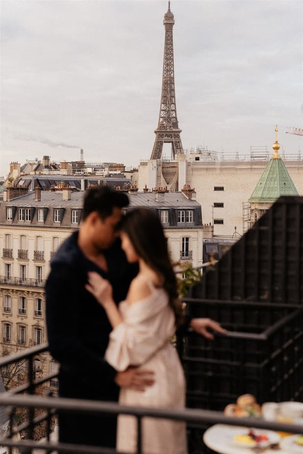Breakfast on a rooftop terrace pre-wedding shoot with a breathtaking view of Paris's skyline and Eiffel Tower