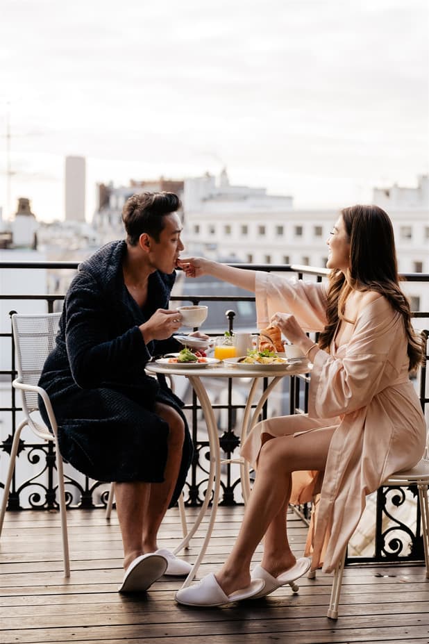 Breakfast on a rooftop terrace pre-wedding shoot with a breathtaking view of Paris's skyline and Eiffel Tower