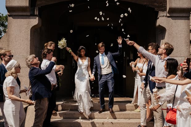 Wedding ceremony petal toss with bride and groom