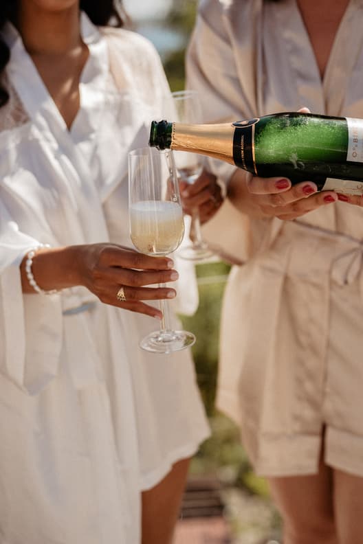 Bride Celebrating With Champagne with Bridesmaids 