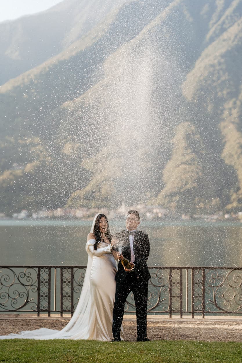 Villa Balbiano elopement wedding destination couple popping champagne Italy destination wedding photographer videographer