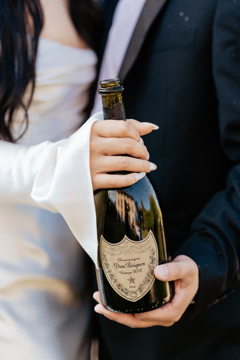 Villa Balbiano elopement wedding destination couple popping champagne Italy destination wedding photographer videographer
