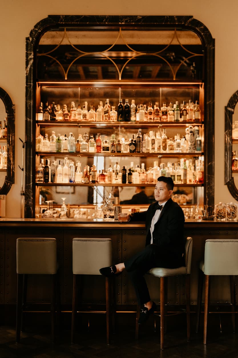 Elopement wedding Mandarin Oriental groom drinking and preparing at the bar Italy destination wedding photographer videographer
