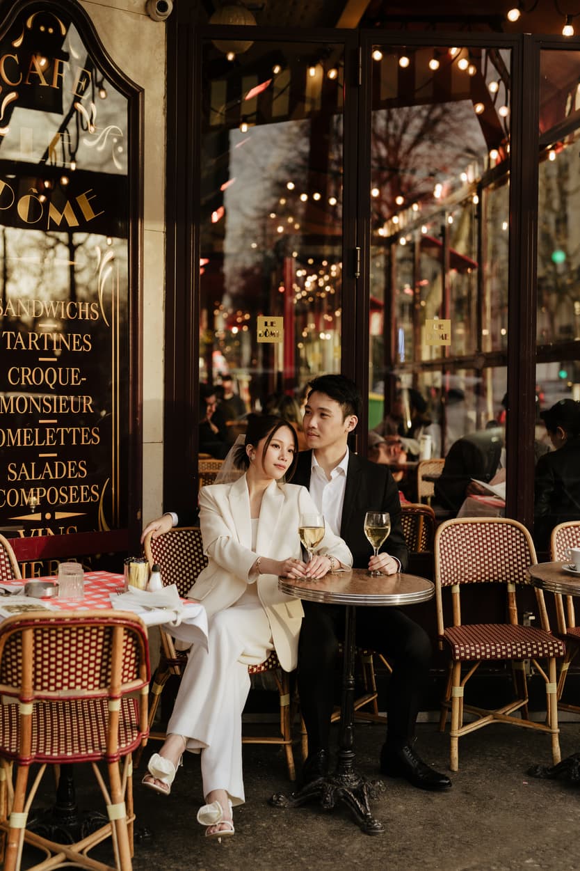 Couples Sunset Pre-wedding Photoshoot holding wine in Paris café Street 
