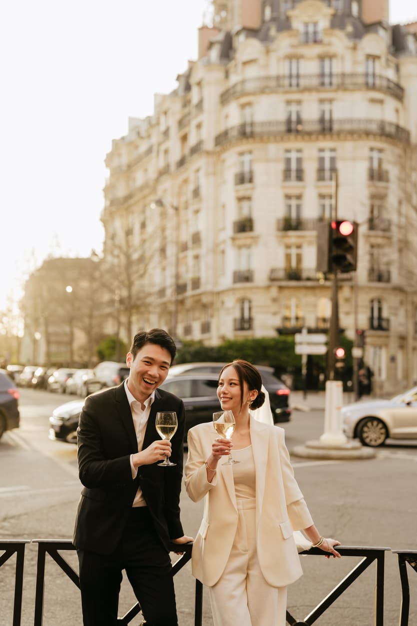 Couples Sunset Pre-wedding Photoshoot holding wine in Paris café Street 