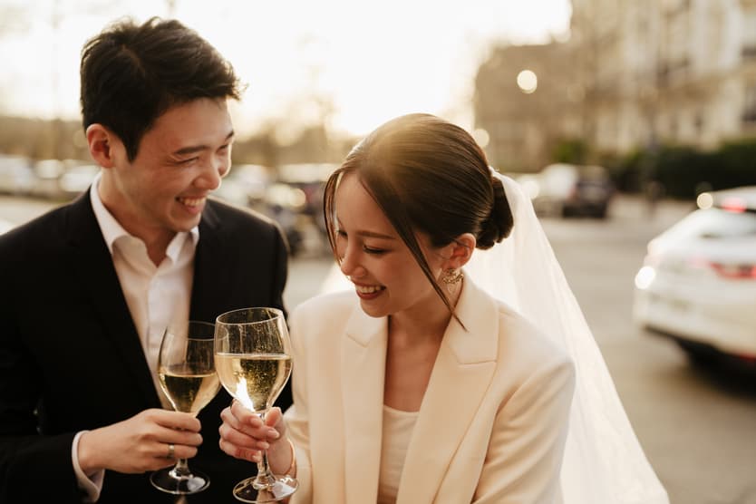 Couples Sunset Pre-wedding Photoshoot in Paris Street toasting with wine 