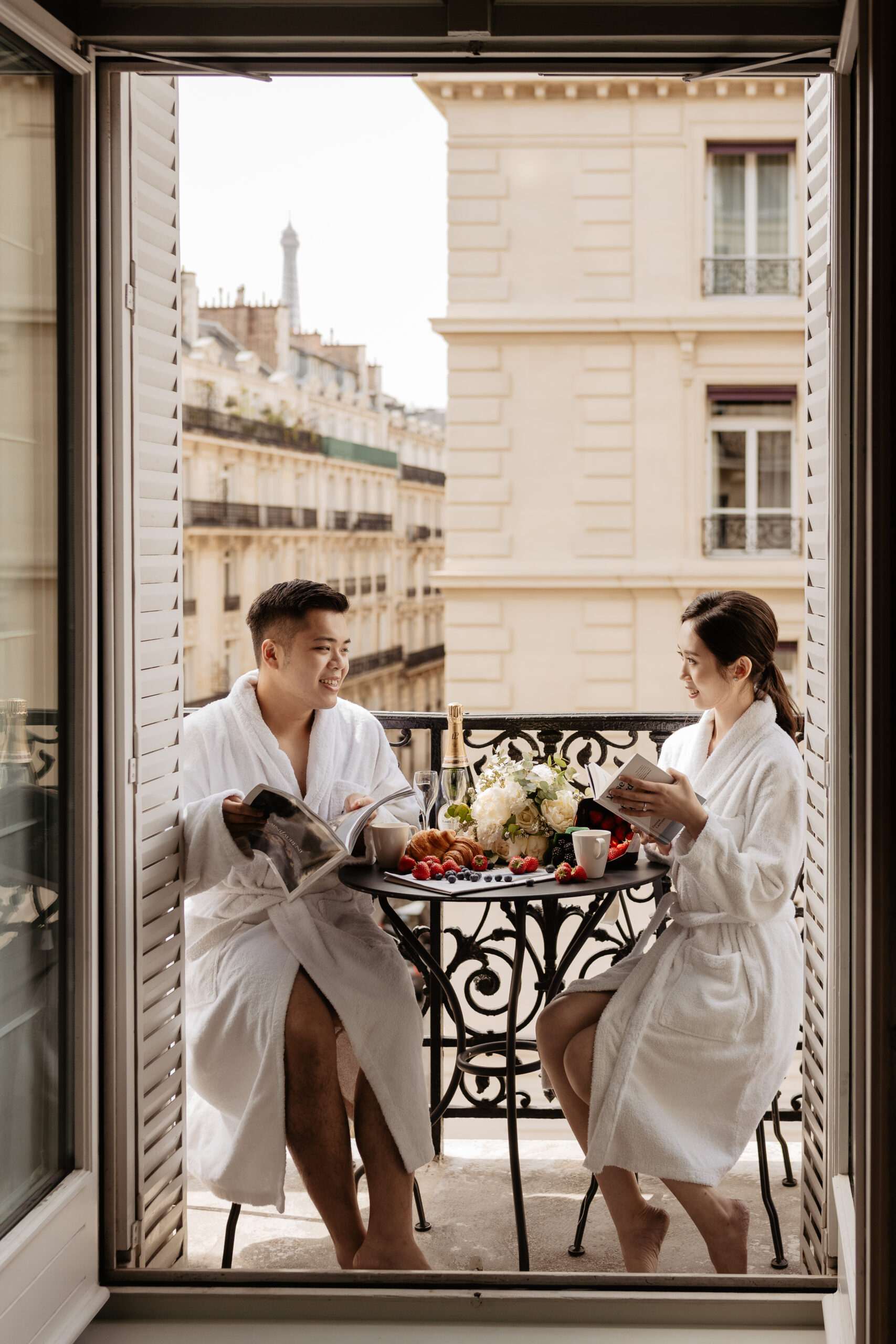 Couple full-day Pre-wedding Photoshoot in Paris hotel balcony with couple having breakfast 