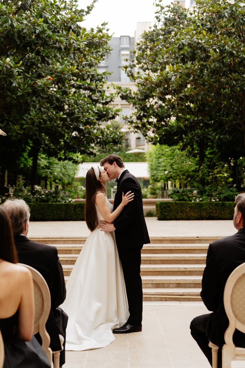 Destination wedding elopement at the luxurious Ritz Paris garden ceremony kiss