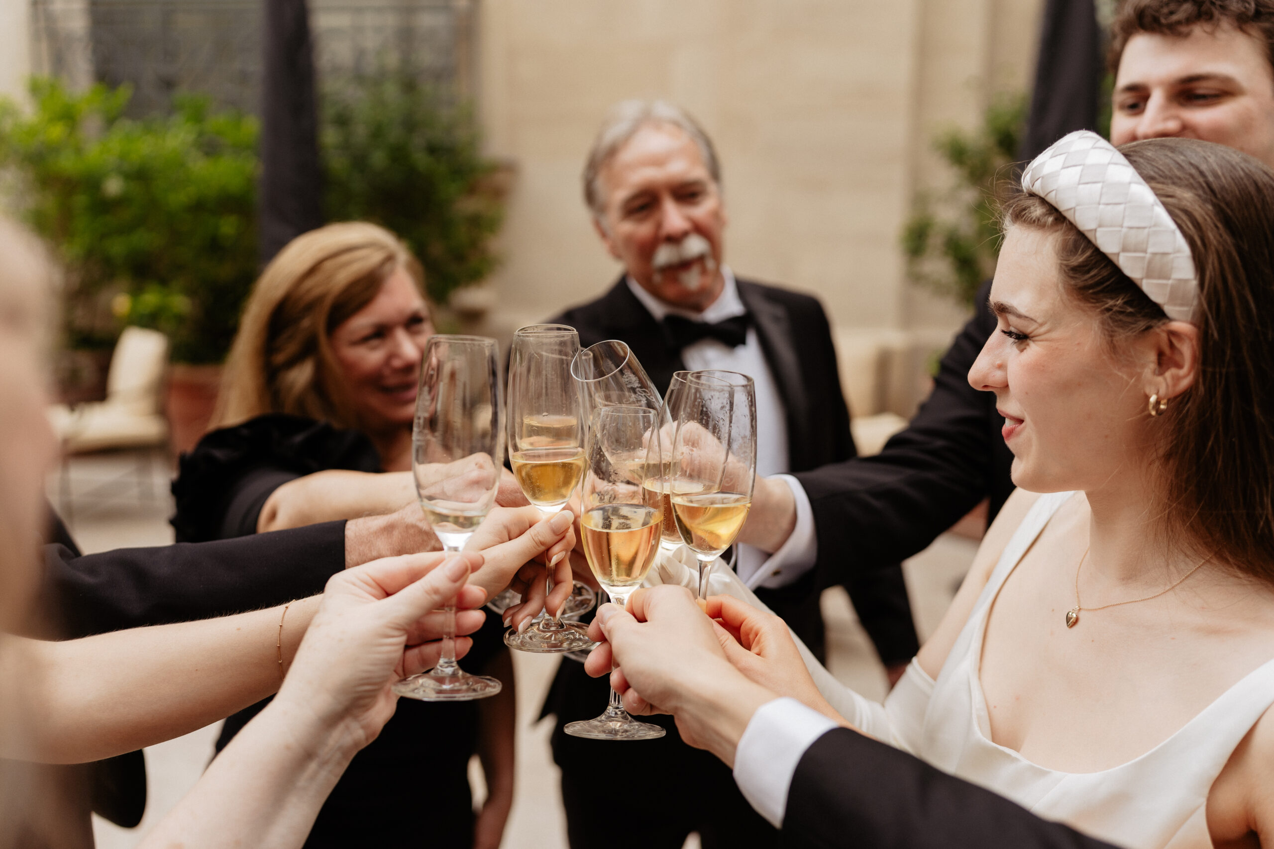 Destination wedding elopement at the luxurious Ritz Paris couple and families toasting 