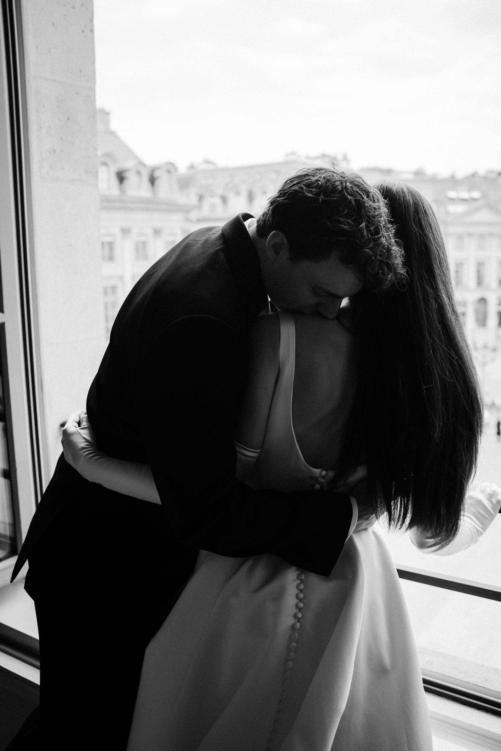 Destination wedding elopement at the luxurious Ritz Paris couple in Chanel's suite groom kissing bride's shoulder