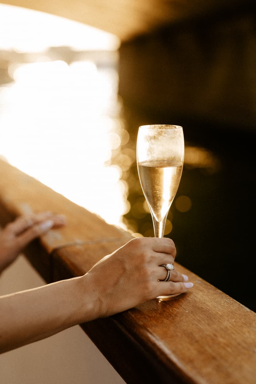 A glass of champagne on the boat’s rail at the welcome dinner, the Seine behind it
