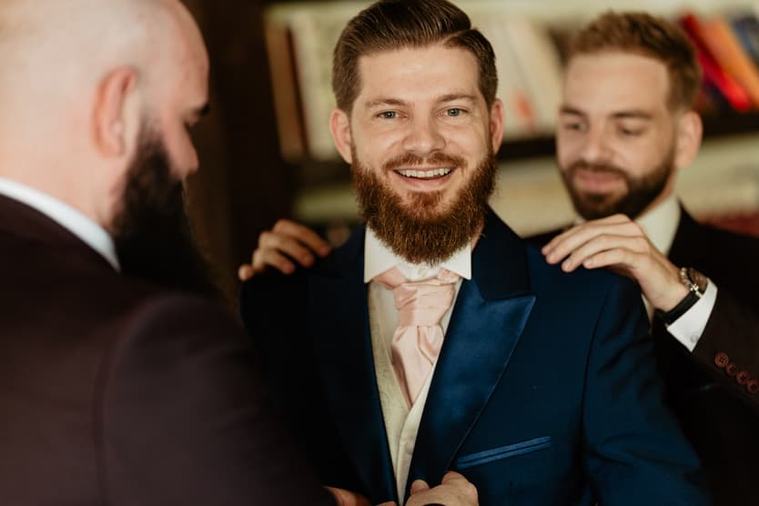 The groom getting ready with his friends in the château library