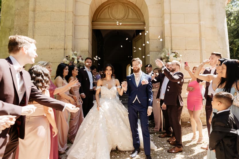 Confetti thrown over the bride and groom as they come out of the church, their guests on both sides