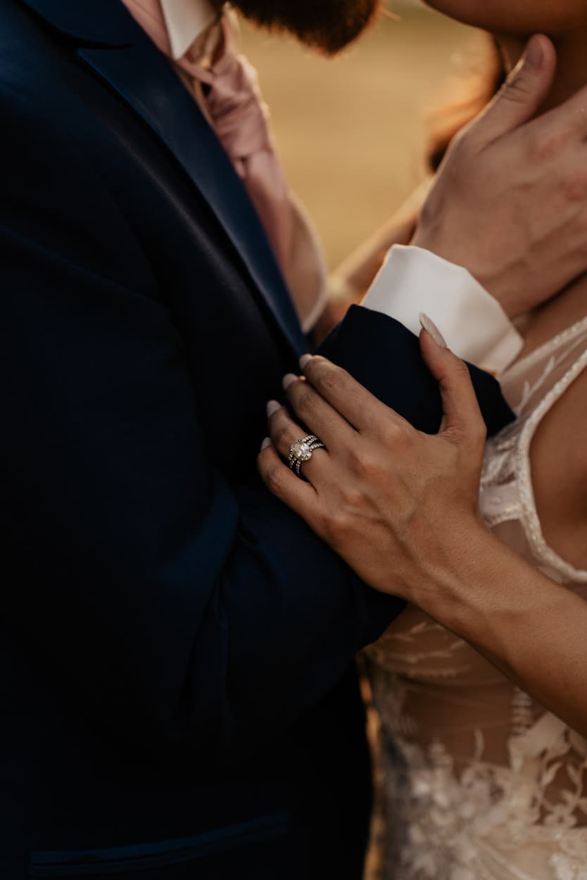 The groom turning the bride under his arm beside the château fountain at sunset