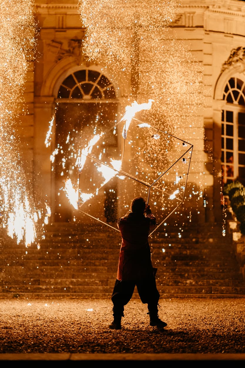 Sparks falling across the front of the château during the evening fire show