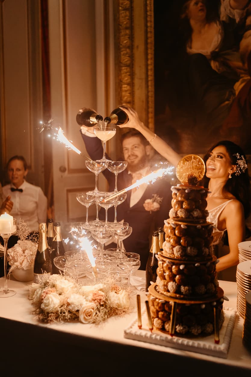 The champagne tower and the croquembouche carried in, sparklers over the dessert table