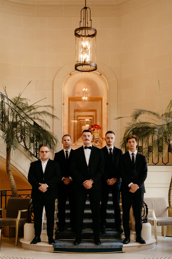 Destination elopement wedding Paris preparations Hotel du Louvre groom with bestmen 