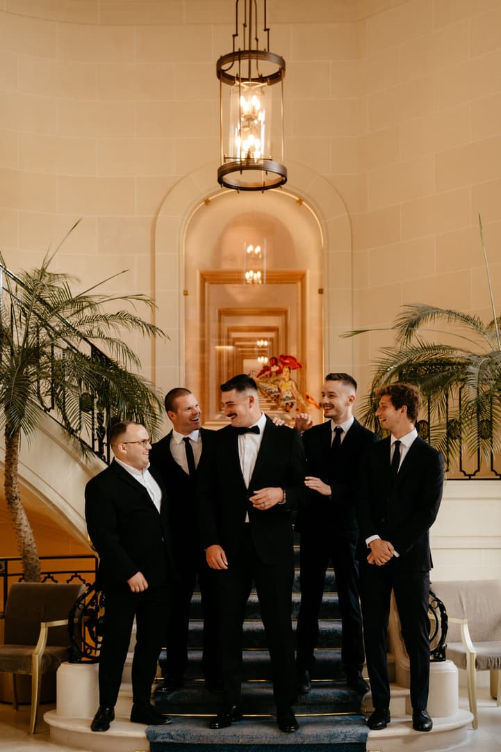 Destination elopement wedding Paris preparations Hotel du Louvre groom with bestmen 