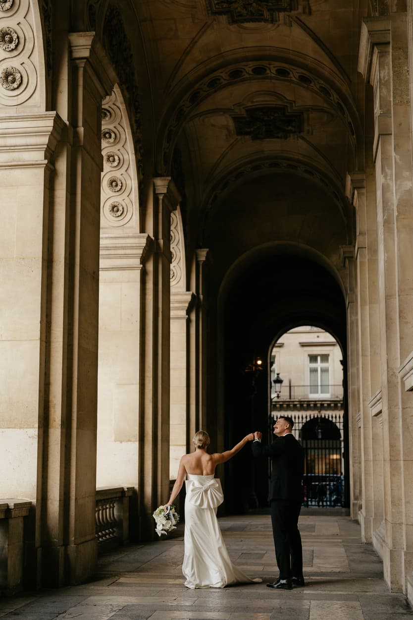 Destination elopement wedding Paris Louvre hallway couple dancing 