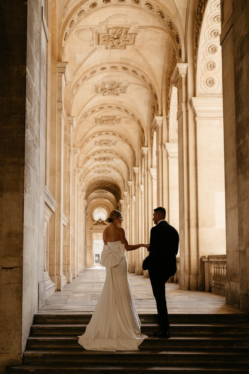 Destination elopement wedding Paris Louvre hallway couple posing 
