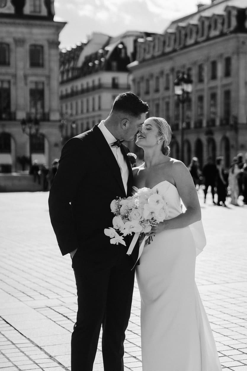 Destination elopement wedding Paris Place Vedome couple about to kiss