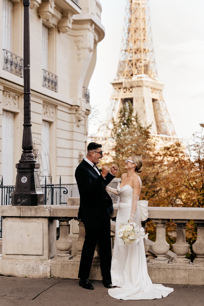 Destination elopement wedding Paris street with Eiffel Tower view couple joking