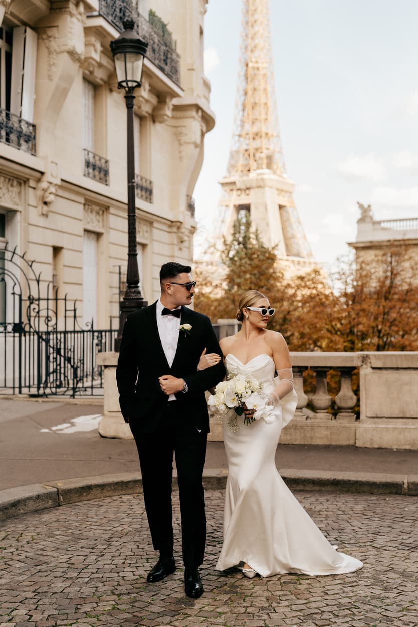 Destination elopement wedding Paris street with Eiffel Tower view couple walking
