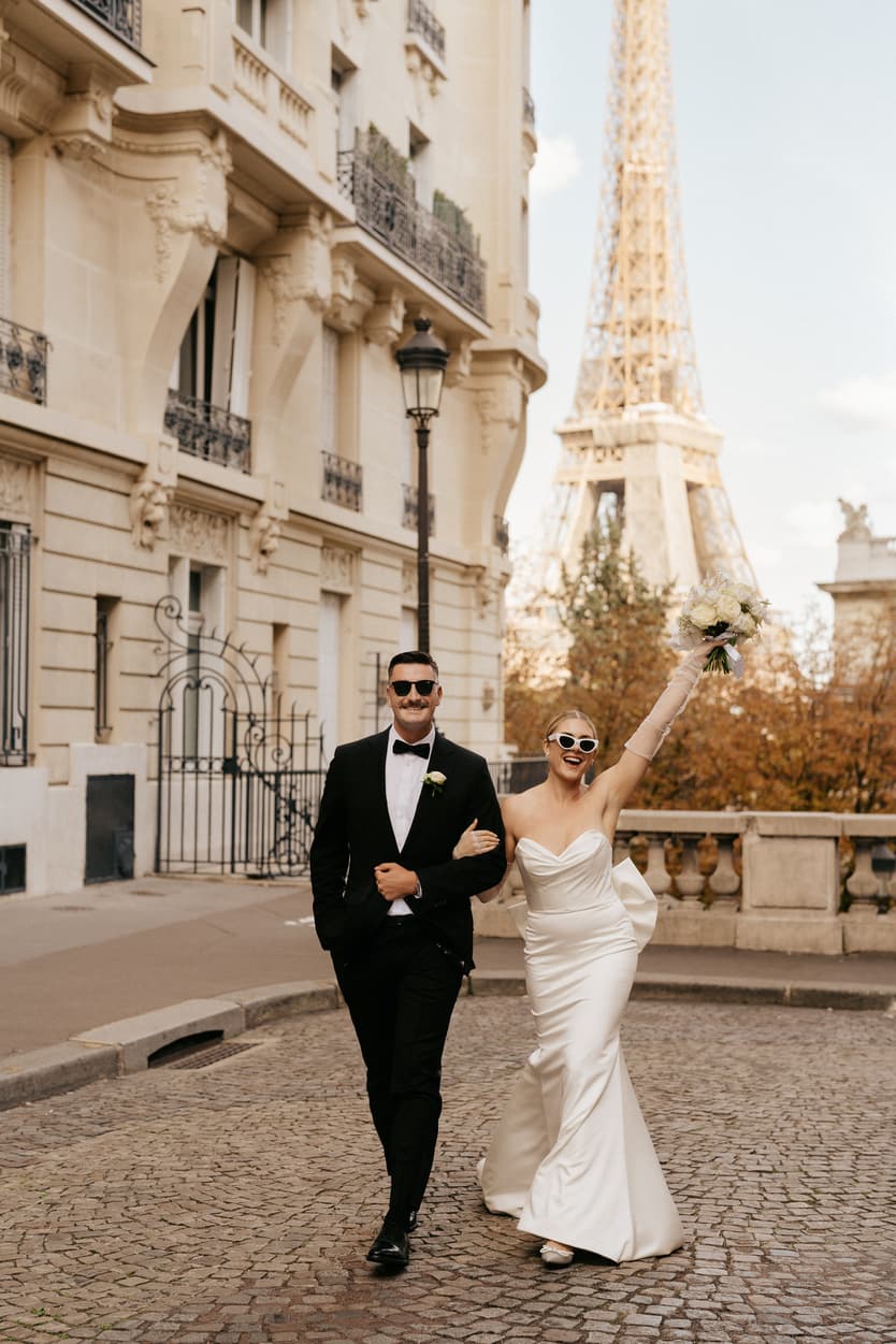 Destination elopement wedding Paris street with Eiffel Tower view couple walking 