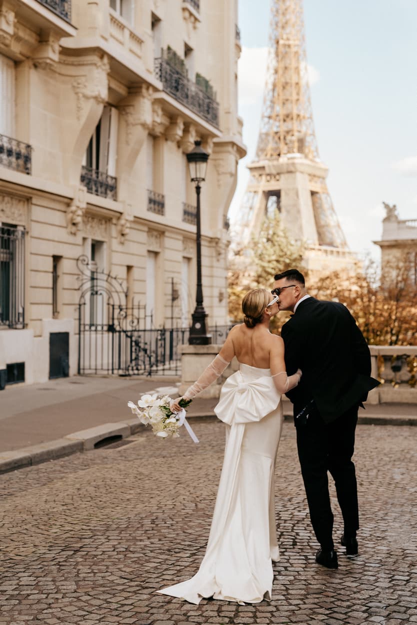 Destination elopement wedding Paris street with Eiffel Tower view couple kissing