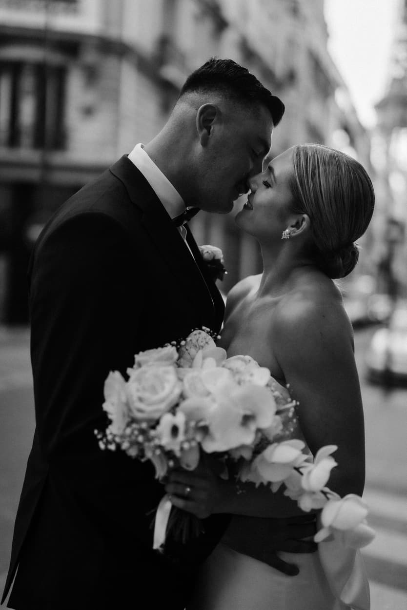 Destination elopement wedding Paris street couple about to kiss