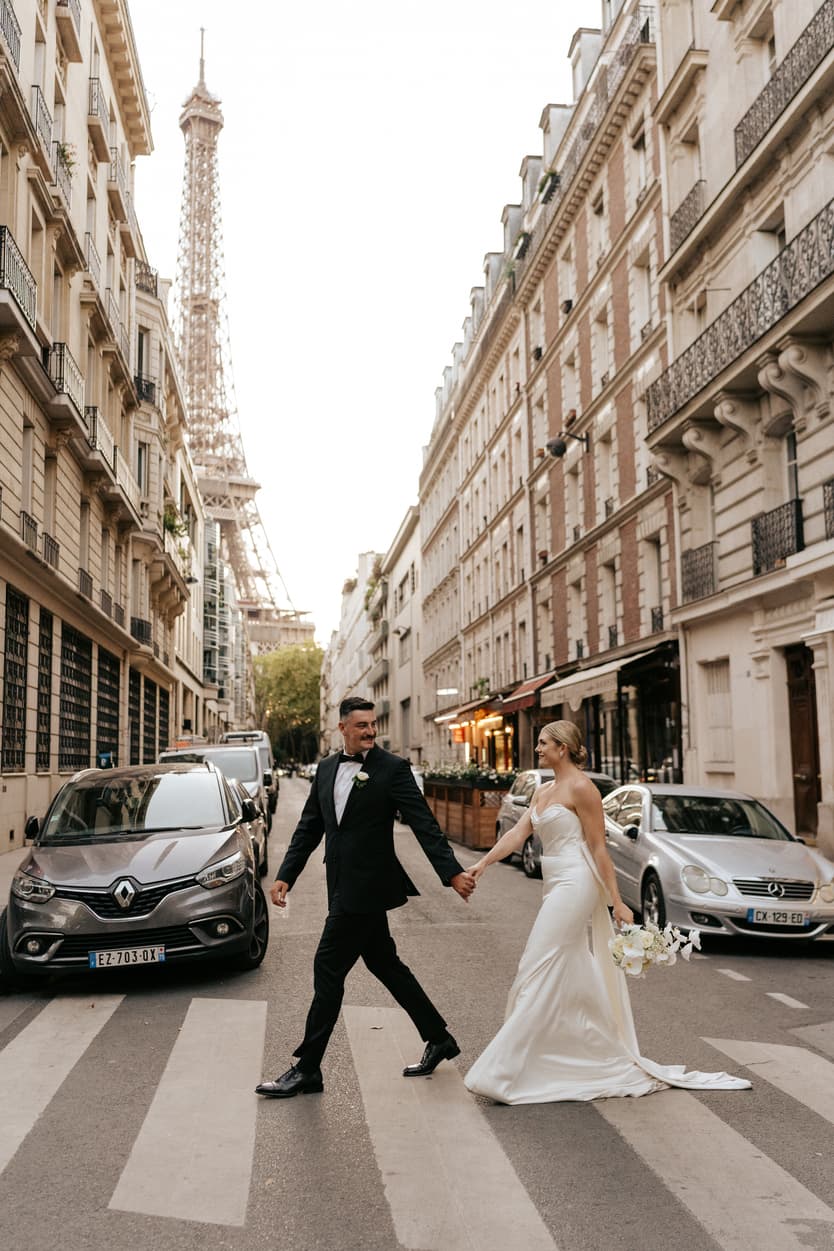 Destination elopement wedding Paris street with Eiffel Tower view couple crossing street