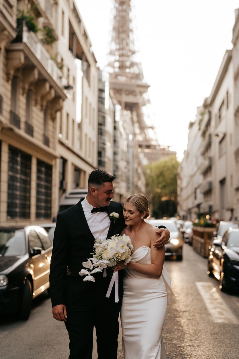 Destination elopement wedding Paris street with Eiffel Tower view couple walking