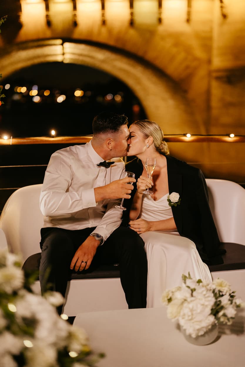 Destination elopement wedding Paris yacht couple kissing 