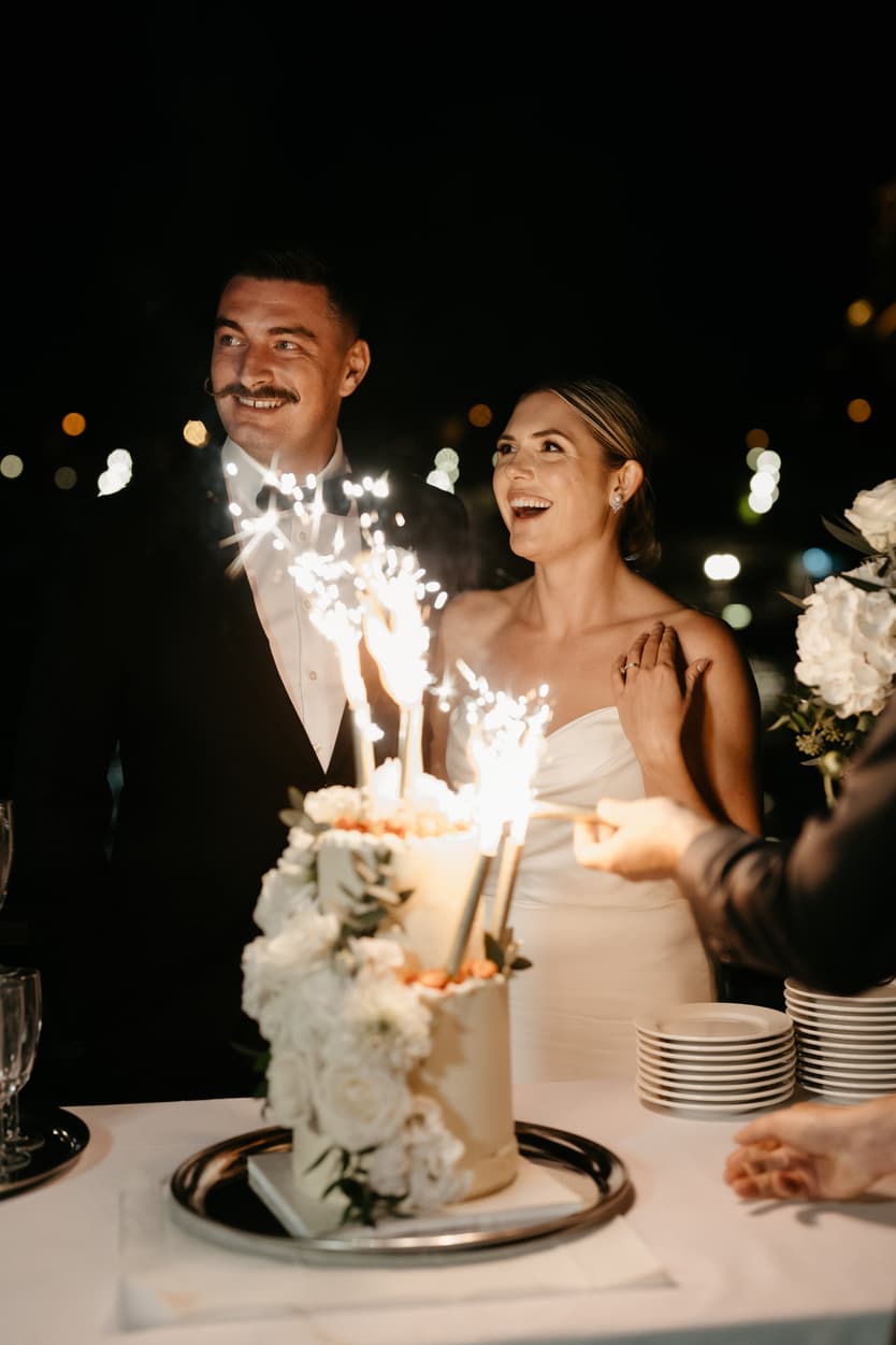 Destination elopement wedding Paris yacht couple with cake 