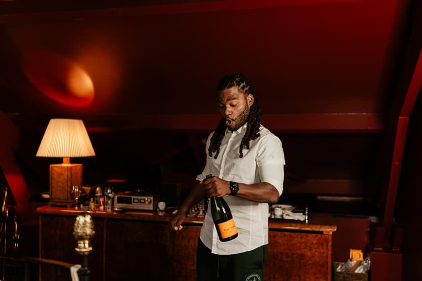 Destination elopement wedding Hotel Particulier Montmartre, Paris preparations groom popping champagne