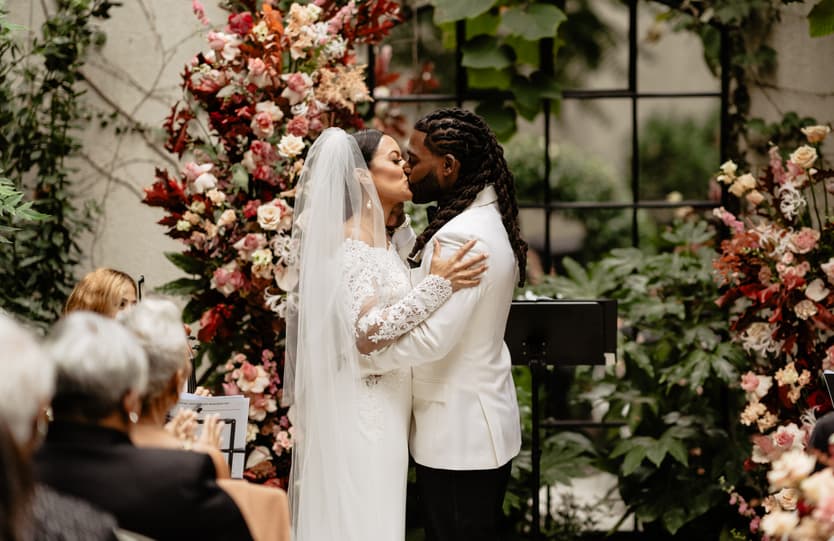 Destination elopement wedding Hotel Particulier Montmartre, Paris garden ceremony couple kissing 