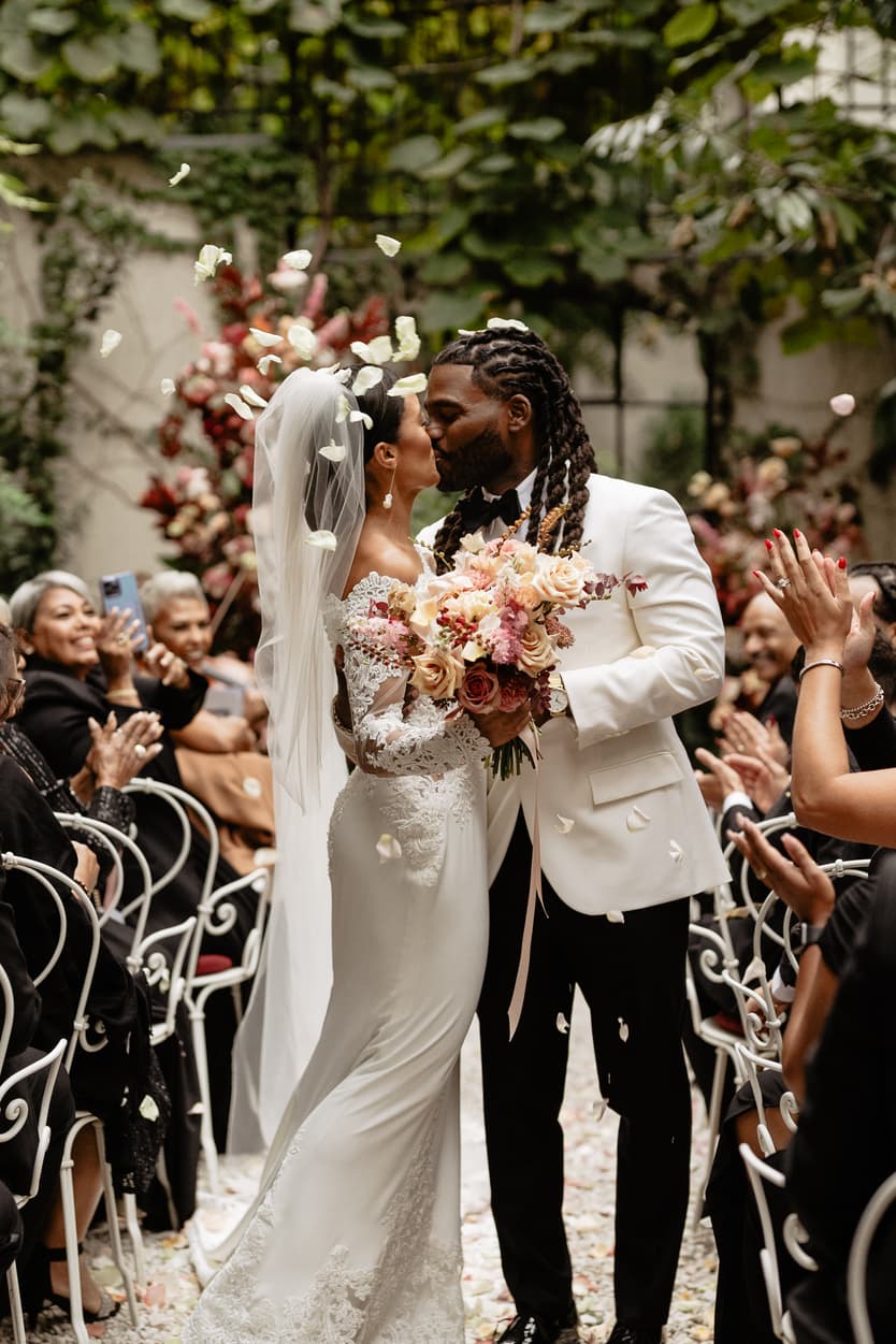 Destination elopement wedding Hotel Particulier Montmartre, Paris garden ceremony petal toss and couple kissing 