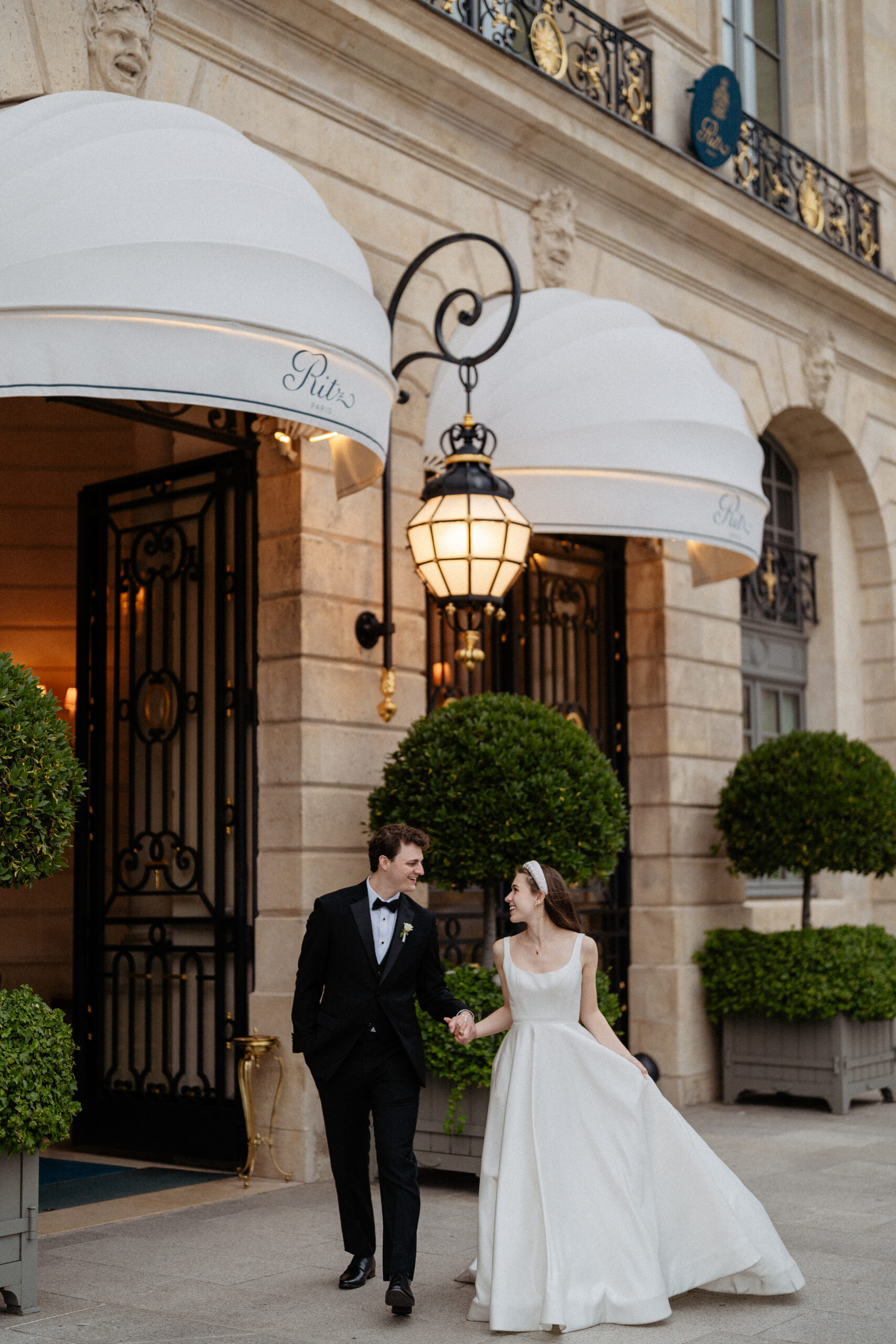 Destination wedding elopement at the luxurious Ritz Paris couple in front of  the hotel 