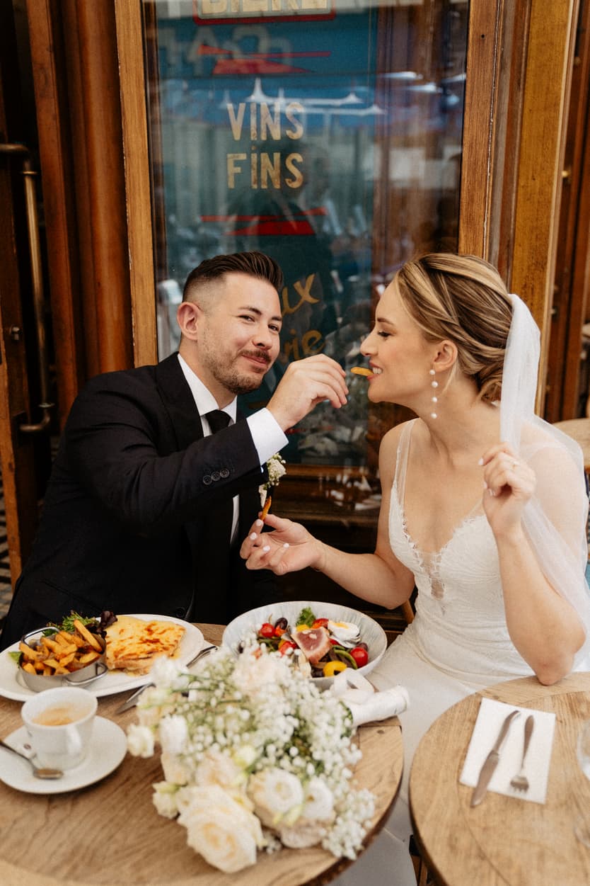 cute couple married making fun at coffee shop in Paris