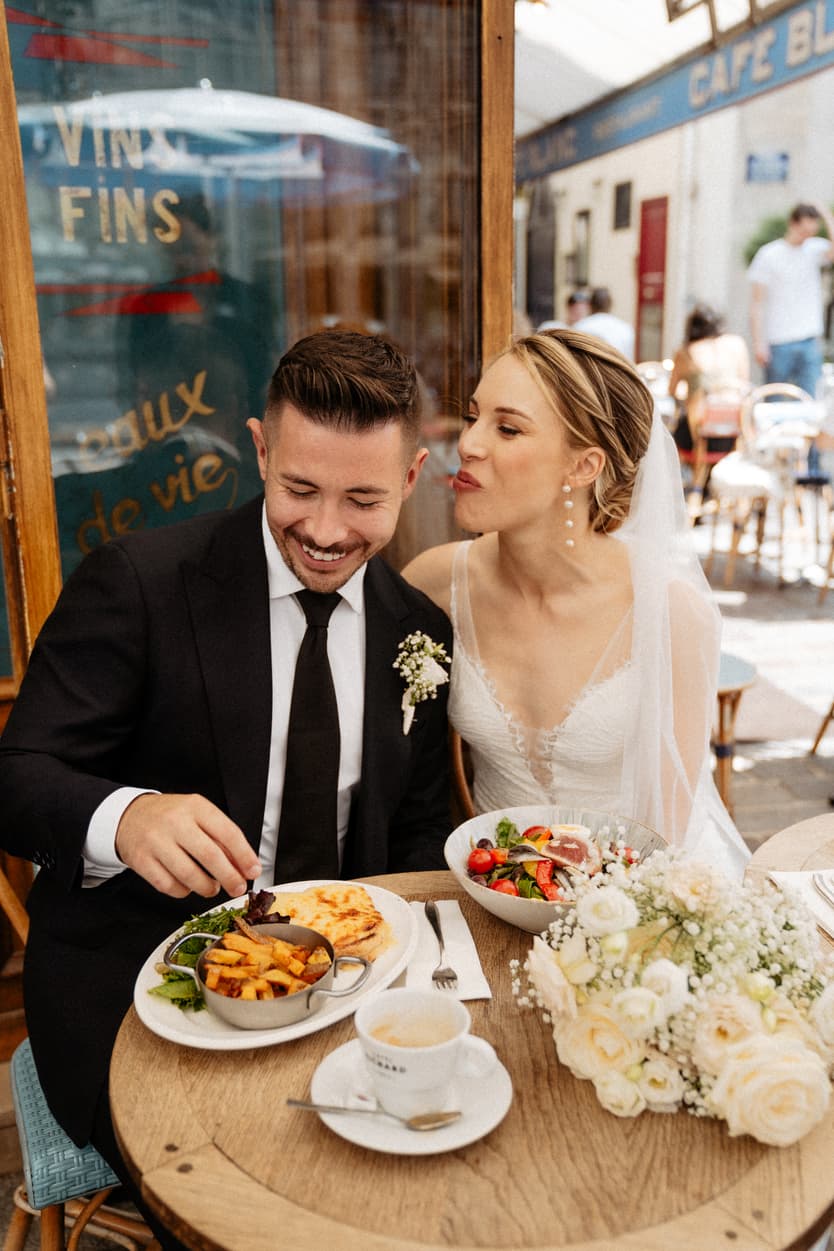 cute couple married making fun at coffee shop in Paris