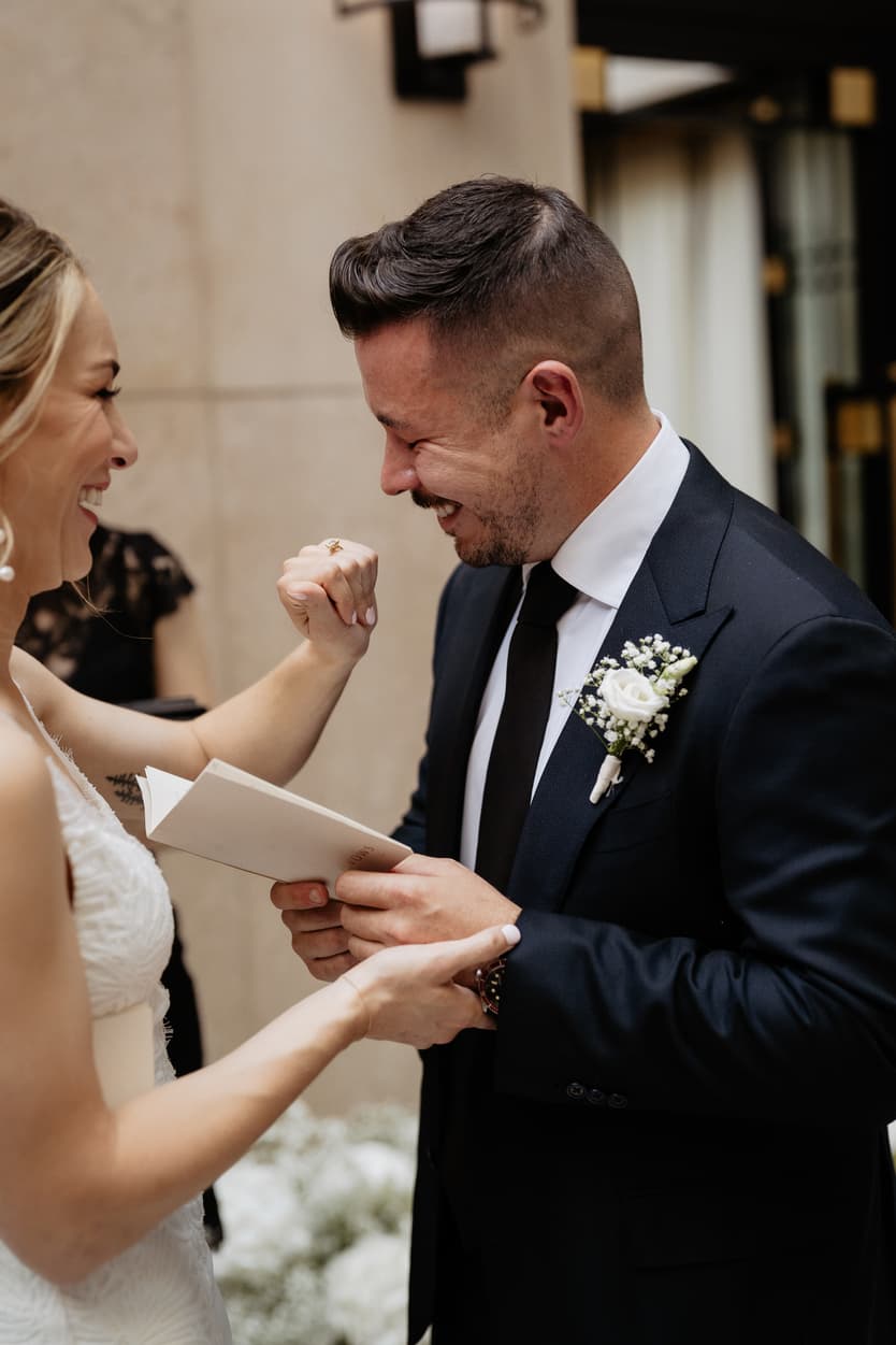 Emotional crying groom reading vows