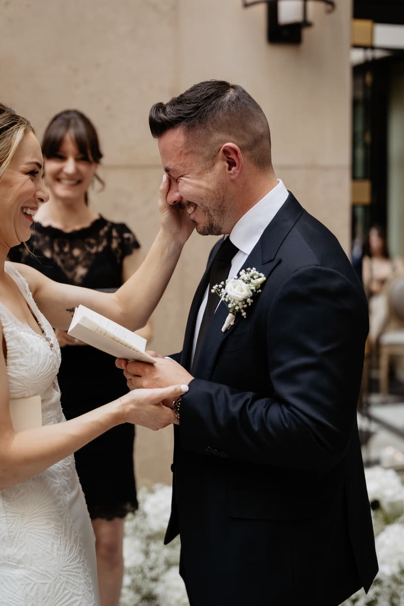 Emotional crying groom reading vows