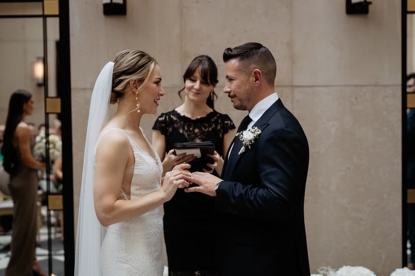 groom and bride happily exchanging wedding ring