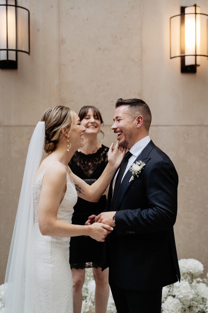 groom and bride happily exchanging wedding ring