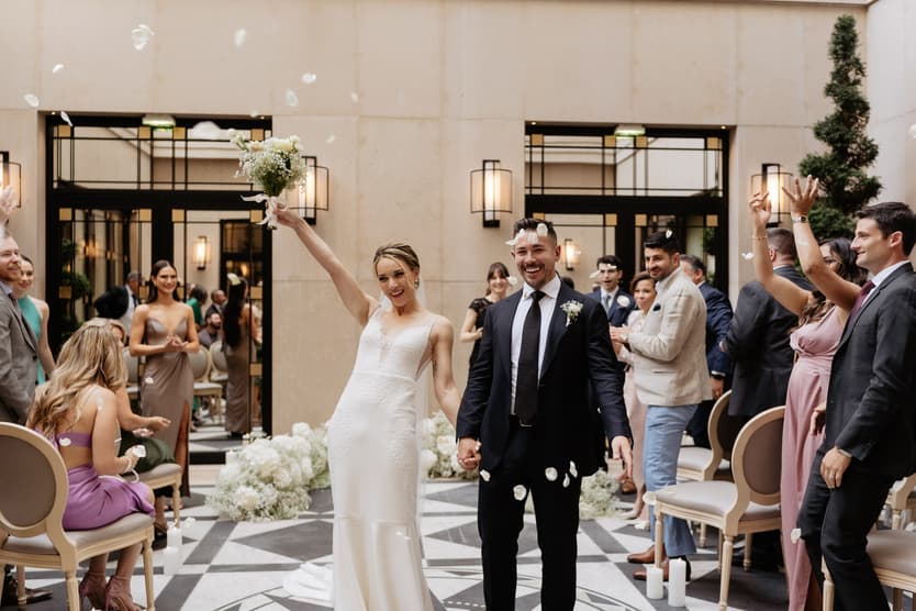 happy newlyweds celebrate with confetti